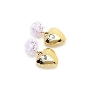 Detail of luxury heart earrings featuring white beaded clusters and polished gold finish