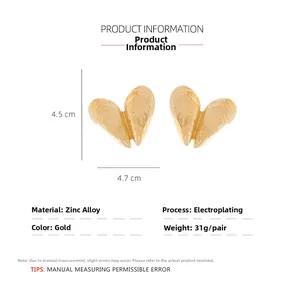Detail view of gold open shell earrings showing texture dimensions and zinc alloy material