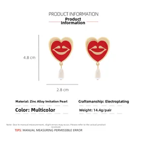 Detailed view of red heart and lip earrings with white faux pearl drop and dimensions