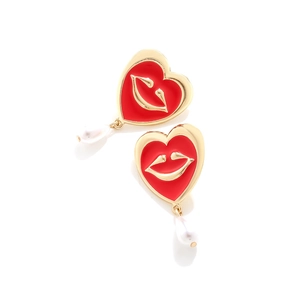 Detail of heart earrings with red enamel lips and drop-shaped pearl pendants