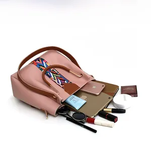 Pink pebbled leather handbag interior showing large capacity for tablet and cosmetics