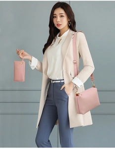 Close-up of a pink matte leather shoulder bag and matching long zipper wallet with gold hardware