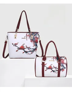 Detail of two-piece tote and Boston bag set with red plum print and gold hardware