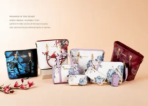 Detail of luxury handbag set featuring floral patterns and gold chain accessories