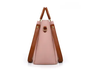 Pink and brown PU leather handbag detail showing side profile and gold hardware