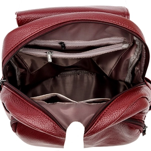 Detail view of burgundy leather backpack showing large interior space and pockets