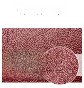 Macro detail of waterproof burgundy lychee grain leather texture on woman backpack