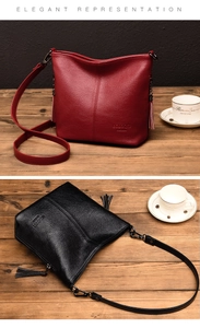 Close-up of litchi-textured leather bucket bags with tassels on vintage wooden table