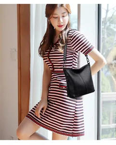 Minimalist black pebble leather hobo shoulder bag with stylish long tassel detail