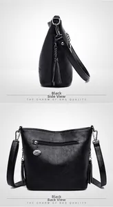 Detail showing black lychee leather texture, fringe tassel, and back zipper on bucket bag