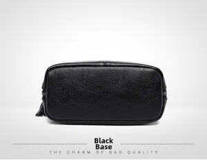Detail view of the black lychee pattern leather handbag base with sturdy stitching