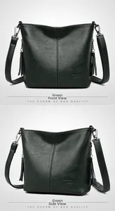Detail of dark green pebble leather bucket bag with tassel charm and brand logo