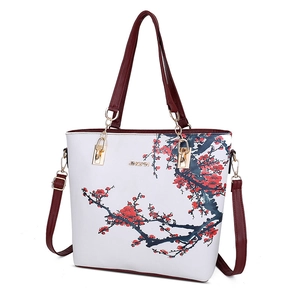 White faux leather tote bag with red plum blossom print and burgundy straps