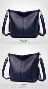 Detail of dark blue pebble leather bucket bag with tassels and silver metal hardware