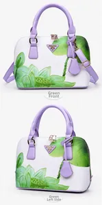 Front and side view of purple and white shell handbag with green lotus print and top handle
