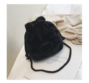 Detail of fluffy black faux fur bucket bag with cute animal ears and drawstring closure
