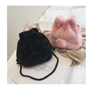 Detailed view of plush drawstring bucket bags with cute 3D ears in black and pink fur