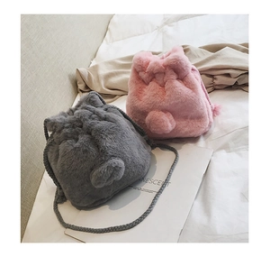 Close-up of pink and grey faux fur bucket bags with soft plush texture and drawstring