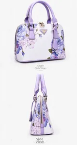 Detail view of floral shell bag with purple rose print and metal logo plaque