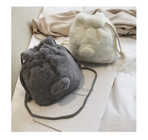 Close-up of plush bucket bag with cute bear ears and drawstring closure in grey and white