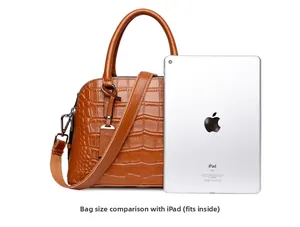 Brown crocodile pattern Boston bag showing interior capacity to fit a tablet device