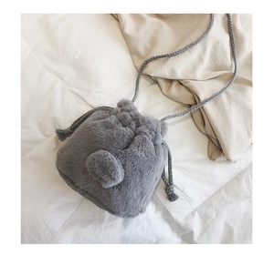 Detailed top view of a dark grey faux fur bucket bag with a plush tail and drawstring closure