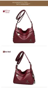 Detail of wine red soft leather shoulder bag with V-shaped quilting and metal logo