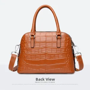 Back view of a brown crocodile embossed leather dome handbag with silver hardware and straps