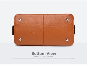 Detailed base view of brown leather bag showing four silver protective metal feet studs
