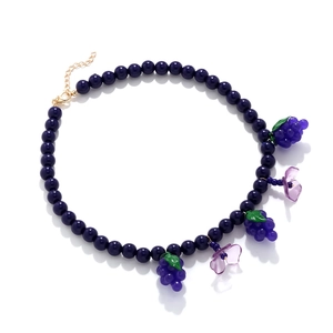 Detail of beaded grape and flower necklace with golden lobster clasp and chain