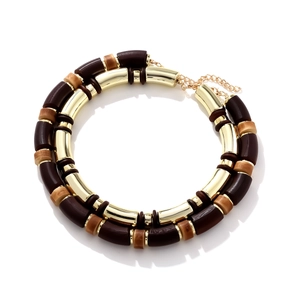 Detail of layered geometric wooden beads and golden resin necklace with extension chain