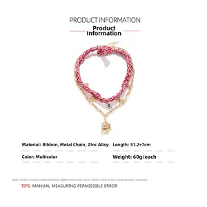 Detailed view of woven ribbon necklace with starfish and seashell alloy pendants