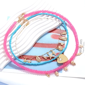 Layered ocean theme necklace set with starfish, seashell and heart charms on gold chain