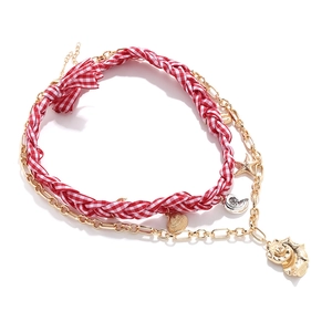 Layered beach necklace with red woven cord, starfish and seashell charms in gold finish