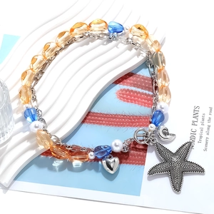 Macro view of multi-layer beaded ocean necklace with starfish, conch, and heart pendants