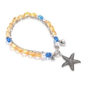 Detail of layered ocean theme necklace with starfish pendants and blue yellow beads