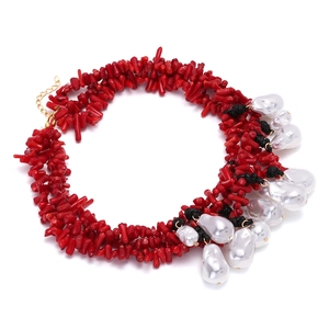 Elegant woven red coral branch necklace featuring baroque pearls and golden chain