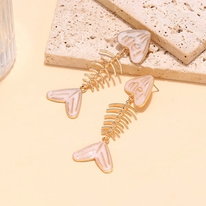 Detail of pink enamel fishbone earrings with heart-shaped head and 'me!' engraving