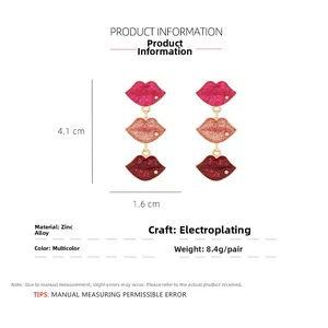 Detailed view of red lip drop earrings showing 4.1cm length and enamel glitter finish
