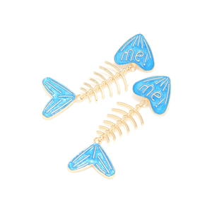 Detail shot of long fishbone earrings with sky blue enamel and golden metal finish