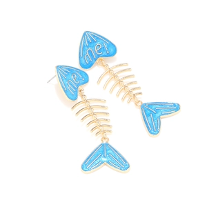 Macro detail of fish bone earrings with sky blue enamel finish and me! letter engraving