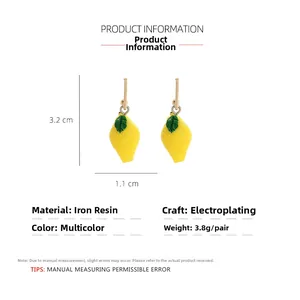 Detail view of yellow lemon earrings with green leaves and precise size dimensions
