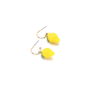 Detailed close-up of lemon fruit earrings featuring textured peel and green leaves