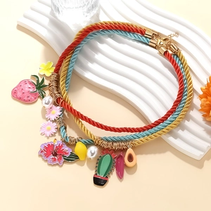 Detailed set of multi-layer woven rope necklaces with strawberry and flower pendants
