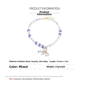 Detail view of pearl necklace with blue ribbon pendant and 41.5cm length measurements