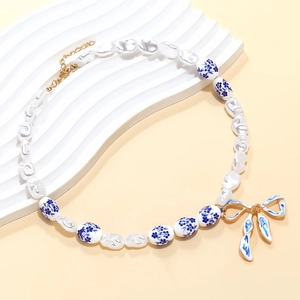 Artistic porcelain beaded necklace with butterfly pendant and baroque pearl accents