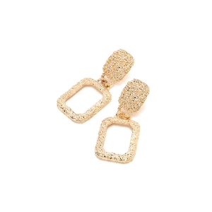 Golden rectangular geometric earrings with vintage hammered texture on white background