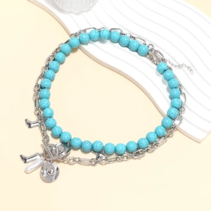 Double-layered western necklace with turquoise beads, cowboy boots, and hat charms