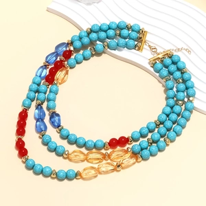 Detail view of Bohemian multi-layer turquoise beaded necklace with gold metal hardware