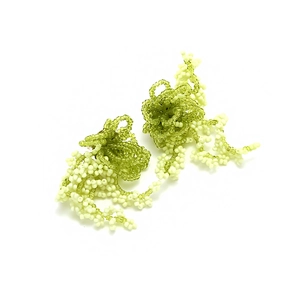 Bohemian handmade beaded fringe earrings with lime green floral weaving on white background